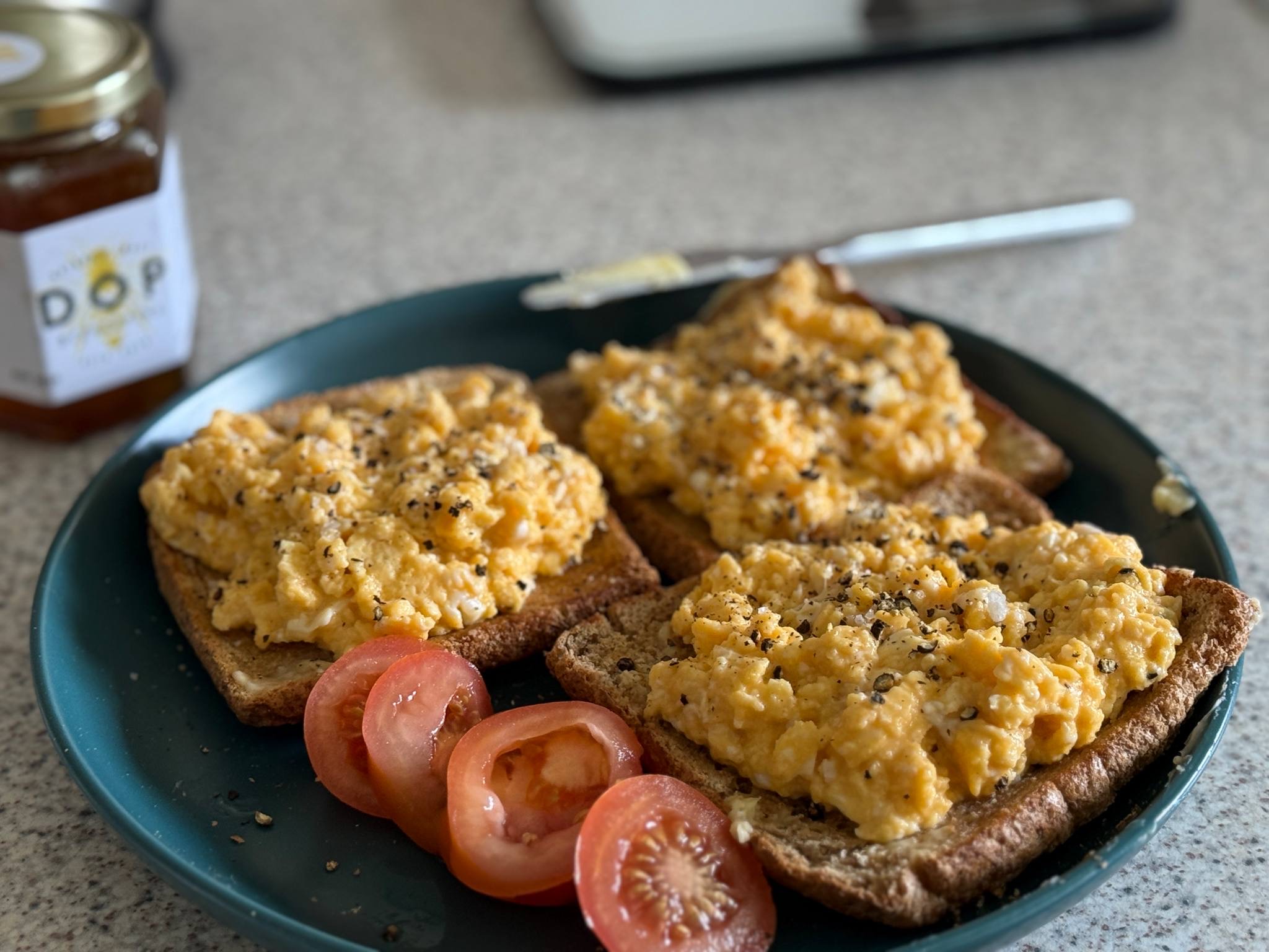 Scrambled eggs on toast with fresh tomatoes — real food for fitness and wellbeing